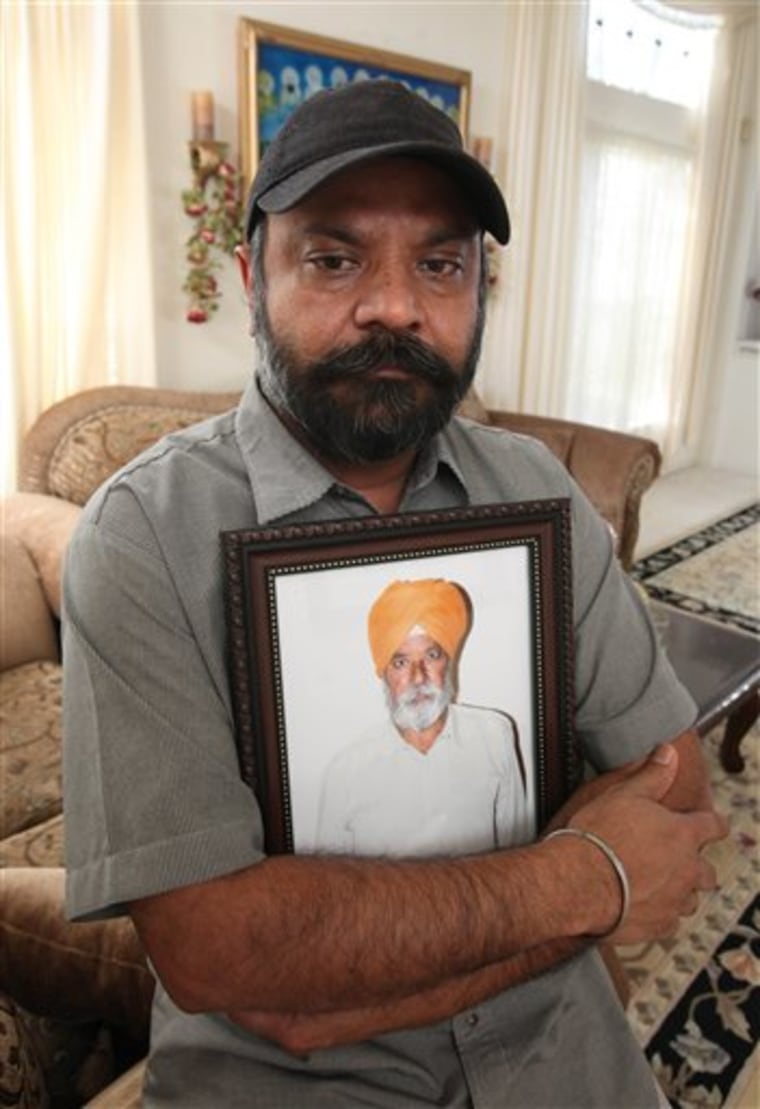 Kamaljit Atwal clutches a photo of his slain father, Gurmej Atwal, in his home in Elk Grove, Calif., on May 19. Gurmej Atwal, 78, and Surinder Singh, 67, where shot in March while taking their daily walk through the neighborhood. Singh died at the scene and Atwal passed away six-weeks after the shooting in what authorities are calling a hate crime. Since Sept. 11, 2001, Sikhs across the U.S. have reported a rise in harassment, assaults and even murders, all because they have been mistaken for Muslim terrorists. 